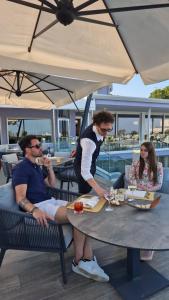 a man sitting at a table with a plate of food at Fantinello Hotel in Caorle