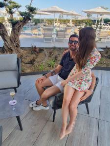 a man and a woman sitting on a chair at Fantinello Hotel in Caorle