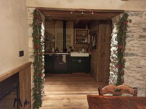 a kitchen with a christmas garland on the wall at Casa La Talpa Dispettosa in Cesani