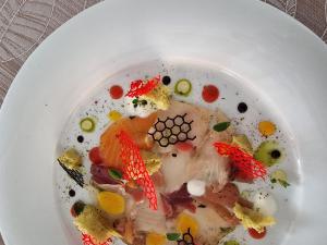 a white plate of food on a table at Fantinello Hotel in Caorle