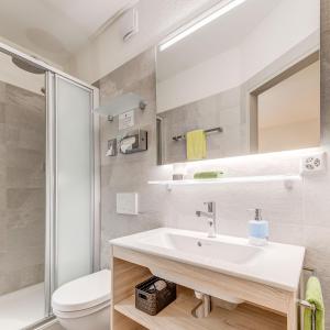 a bathroom with a sink and a toilet at Hotel La Perla in SantʼAntonino