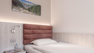 Postel nebo postele na pokoji v ubytování Hotel La Perla