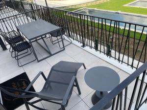 a table and chairs on a balcony with a table and chairs at FOU DU VENTOUX in Malaucène