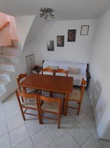 a dining room with a table and chairs and a bed at Cyclops apartment in Serifos Chora