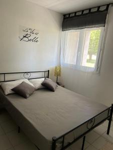 a bed in a bedroom with a window at Chez Chris in Libourne +2 photos