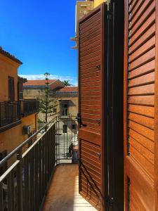 an open door to a balcony with a view at La casa di Serafina in Santo Stefano di Camastra