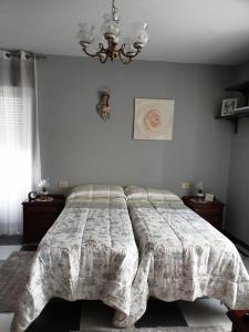 a bedroom with a bed with a comforter on it at ANAMAR in Lugo