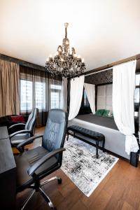 um quarto com uma cama e cadeiras e um lustre em Premium Apt Kosice Center 3 room with PARKING em Košice