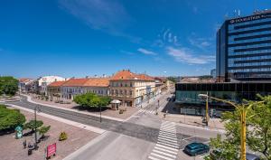 an empty street in a city with buildings at Premium Apt Kosice Center 3 room with PARKING in Košice