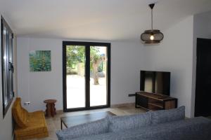 a living room with a couch and a table at Le Clos des Mûriers in Auriolles