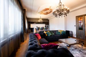 a living room with a couch and a table at Premium Apt Kosice Center 3 room with PARKING in Košice