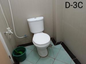 a bathroom with a white toilet in a stall at DCAR Residences - Transient House in Tanza