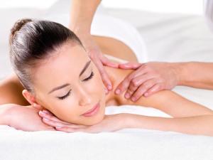 a woman getting a massage from a therapist at Hôtel Le Méditerranée in Hyères