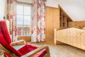 een kamer met een bed, een raam en een stoel bij Ferienhaus Krametergut in Sankt Michael im Lungau