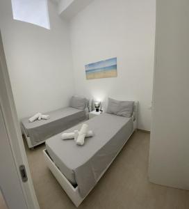 two beds in a small room with at L'Antico Pozzo in Pozzallo