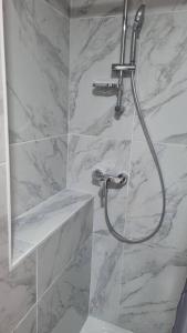 a bathroom with a shower with a sink at Gîte de la confluence in Padern