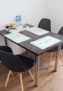 a black table with chairs and papers on it at 33 Coquette Apartment in Baia Mare