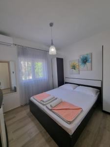 Postel nebo postele na pokoji v ubytování Apartmani Marić + 26 fotografií
