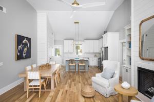a kitchen and living room with a table and chairs at The Jungle House in Edisto Island