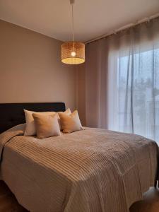 a bedroom with a bed with a large window at Kivikatu Apartment in Rovaniemi