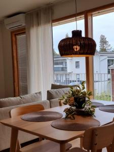 a living room with a table and a couch at Kivikatu Apartment in Rovaniemi