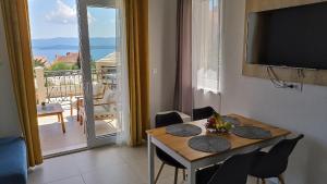 a dining room with a table and a view of a balcony at The Father's House in Bol