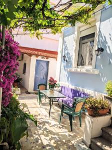 a patio with a purple bench and a table and flowers at House with garden in city of Rhodes in Rhodes Town
