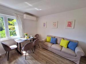 a living room with a couch and a table at Apartment Ivy in Mlini