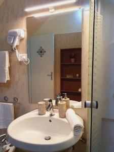 ein Badezimmer mit einem weißen Waschbecken und einem Spiegel in der Unterkunft Sikelia home holiday in Siculiana