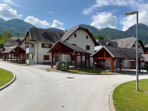 a row of houses with roofs on a street at Timber Apartment in Bohinj