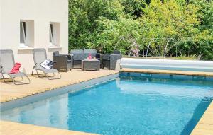 a patio with chairs and a swimming pool at Awesome Home In Canihuel in Canihuel +25 photos