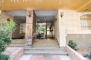 an entrance to a building with concrete stairs at Modern Luxe Oak Orchid 3BR Apt W-Free WiFi &Parking in Cairo