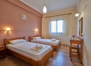 Postel nebo postele na pokoji v ubytování Psarras apartments