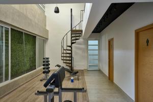 a gym with a spiral staircase in a house at Waterfront views of Historic Zona Colonial in Riviera Colonial in Calero