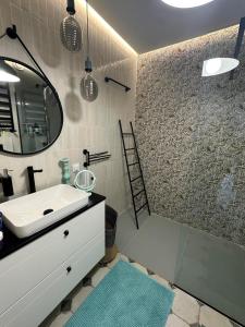bagno con lavandino e specchio di Apartament na Wzgórzu Miętowy a Łańcut