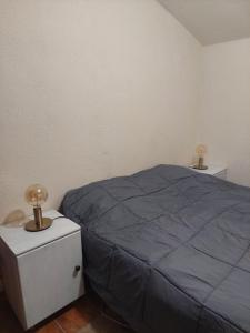 a bedroom with a blue bed and two night stands at Casa da vila de Caria in Caria