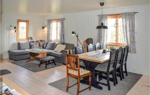 a dining room and living room with a table and chairs at Lovely Home In Kongsberg With Kitchen in Kongsberg