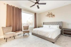 a bedroom with a bed and a chair and a window at Burj Arab Luxury in Tower Grove