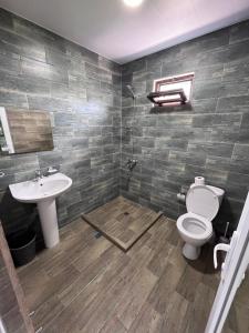 ein Bad mit einem WC und einem Waschbecken in der Unterkunft Guest House Madonna in Kobuleti