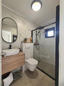 a bathroom with a toilet and a sink and a shower at Harmony Home in Drage +20 photos