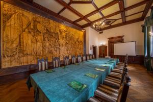 a long table in a room with a large painting at Zamek Kliczków in Kliczków