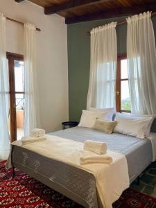 a bedroom with a bed with two towels on it at almond home in Livadia