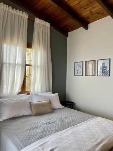 a bedroom with a large bed with a window at almond home in Livadia