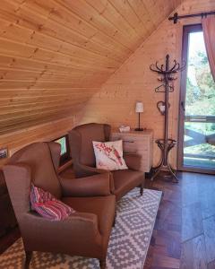 a living room with a couch and chairs in a cabin at Domki na Górniej Łące - Domek Górny in Łazany