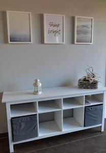 a white console table with white shelves at MOIN & AHOI Ferienwohnung in Boiensdorf