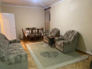 a living room with two chairs and a table at NUR Apartment in Goris in Goris
