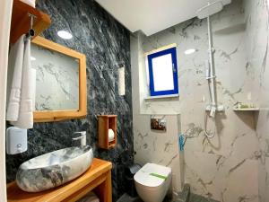 a bathroom with a sink and a toilet at Agropensiunea Paradisul Verde in Jurilovca +54 photos