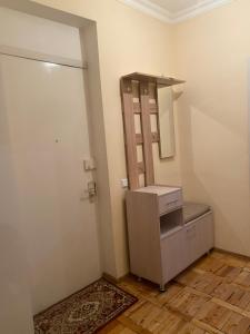 a bathroom with a sink and a mirror next to a door at NUR Apartment in Goris in Goris