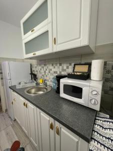 a kitchen counter with a microwave and a sink at La Mary in Old Town in Sibiu +24 photos