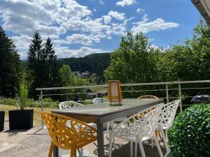 a table and chairs on a patio with a view at Bavaria Mountain Lodge SKI Arber Osser Bayrischer Wald DESIGNER Ferienwohnung in Lohberg
